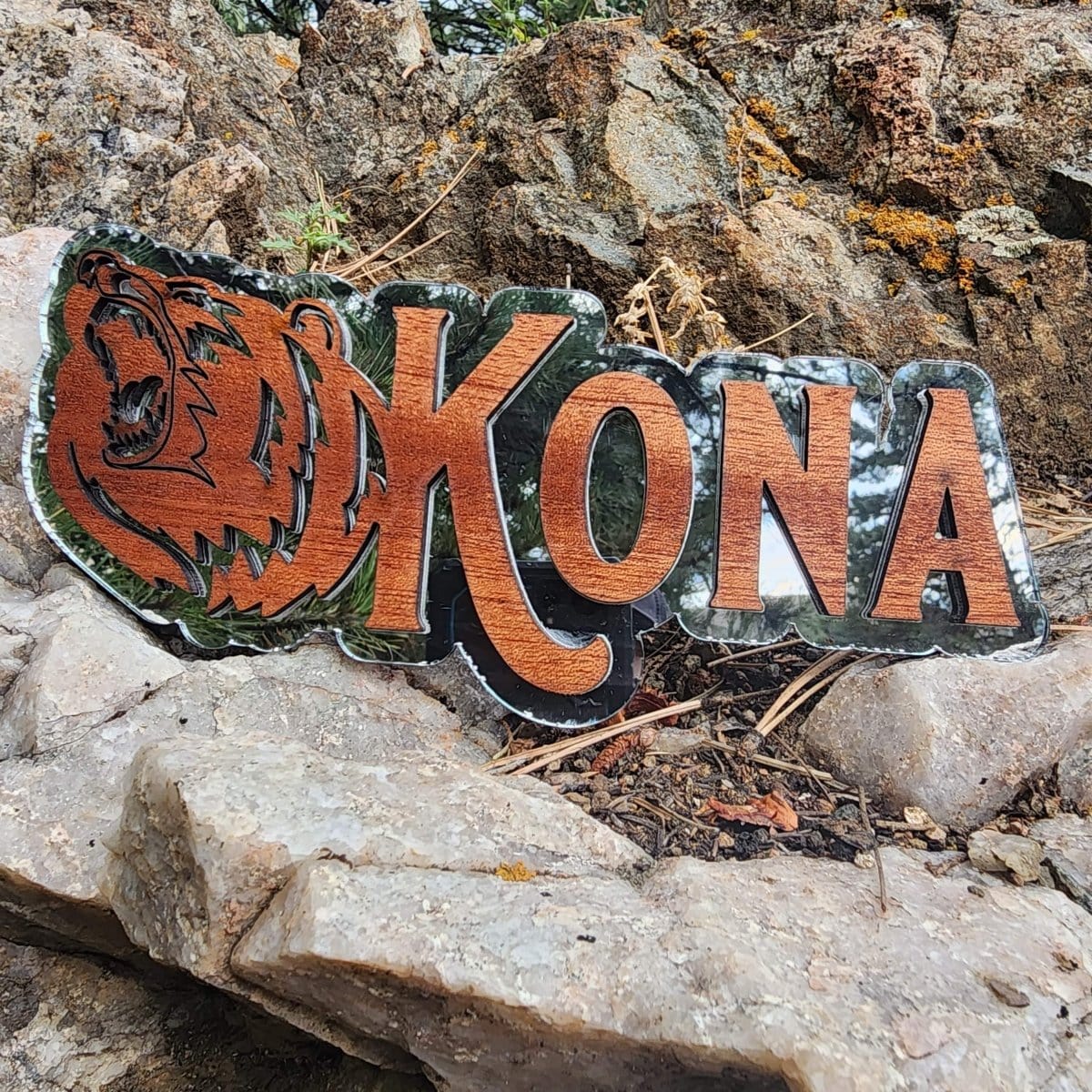 Decorative sign with 'Kona' on a rocky background